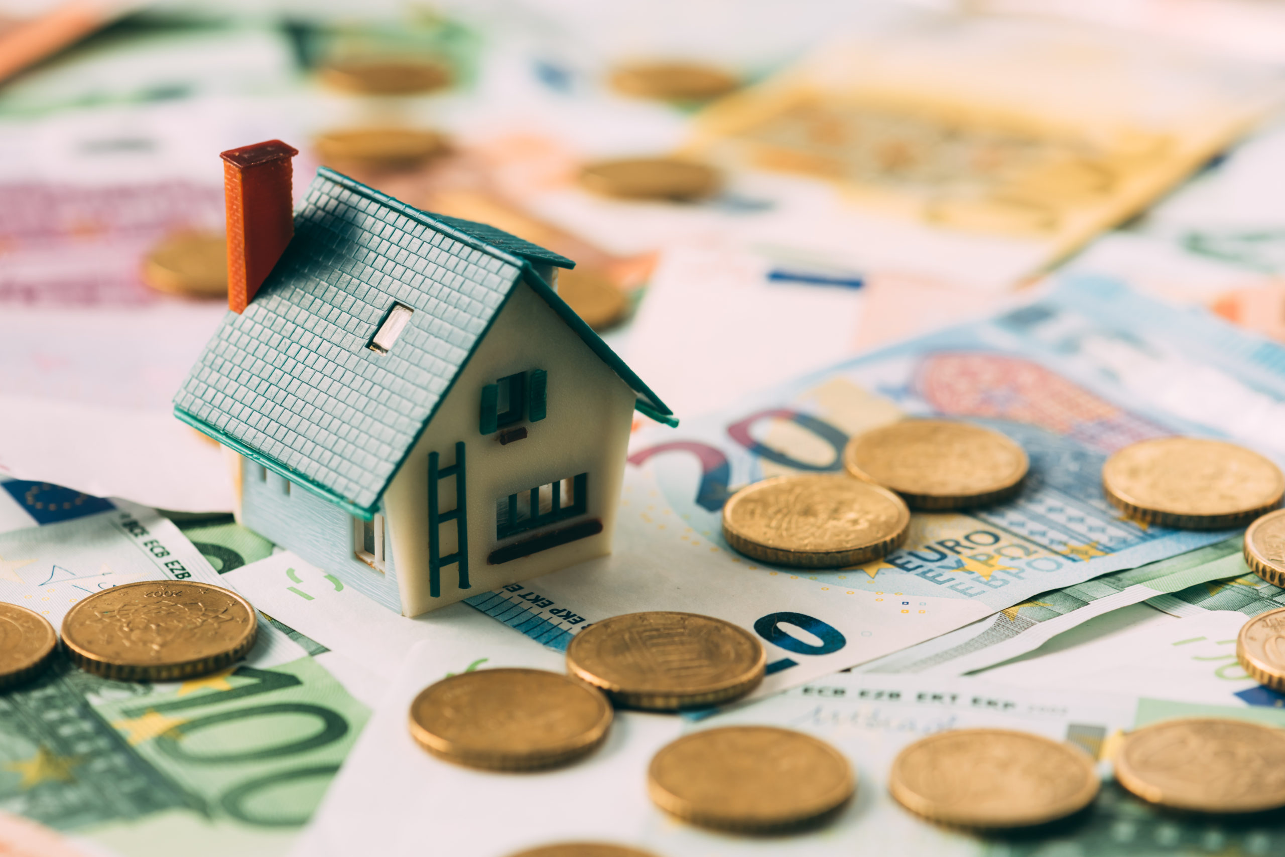 House model on cash stack closeup